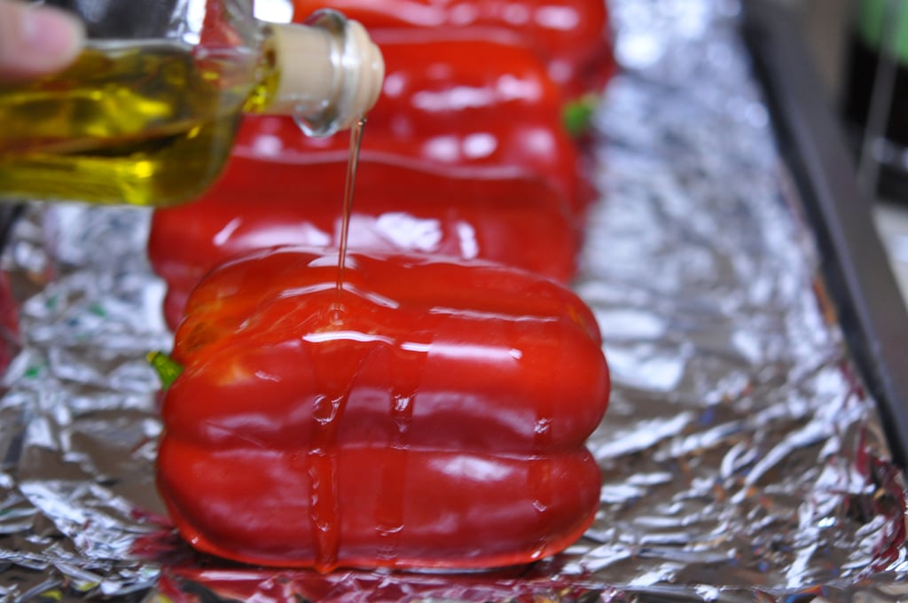 Clean the bell peppers and remove any stickers. Pat the peppers dry.  Preheat the oven to 450°F. Cover a cookie sheet with foil and drizzle olive oil over the red peppers.
