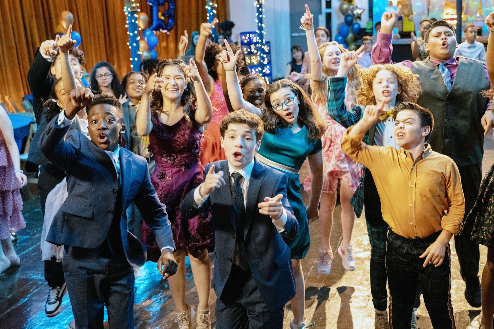 13: THE MUSICAL, (aka THIRTEEN: THE MUSICAL), Ramon Reed (front left), Frankie McNellis (purple dress), Eli Golden (front centre), Shechinah Mpumlwana (centre, rear), Gabriella Uhl (blue dress), Khiyla Aynne (centre right, print dress), Savino Quatela (front right), Luke Islam (right, print tie), 2022. ph: Alan Markfield /  Netflix / courtesy Everett Collection