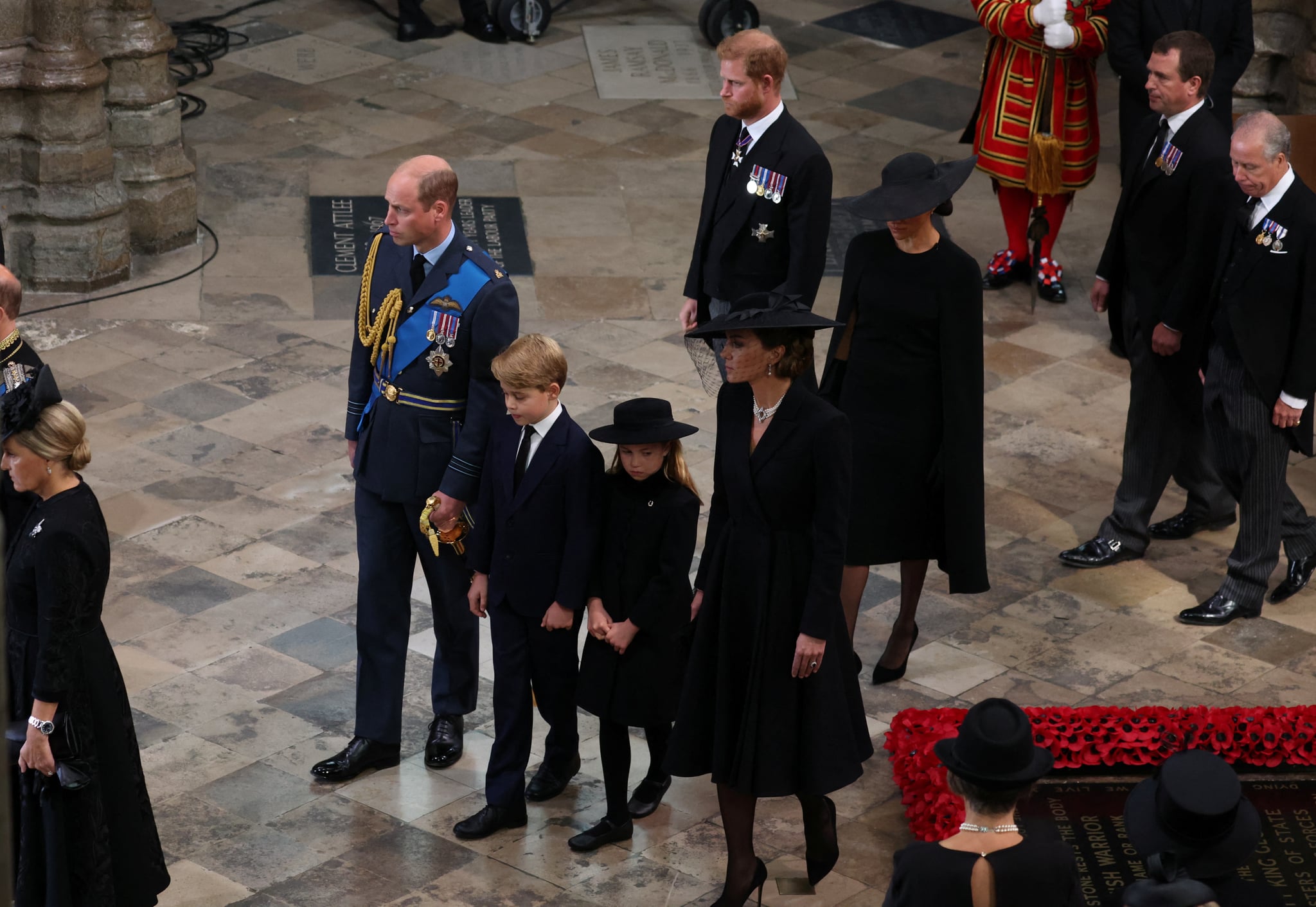 LONDON, ENGLAND - SEPTEMBER 19: Prince William, Prince of Wales, Prince George of Wales, Princess Charlotte of Wales, Catherine, Princess of Wales, Prince Harry, Duke of Sussex and Meghan, Duchess of Sussex follow the coffin of Queen Elizabeth II during the State Funeral of Queen Elizabeth II at Westminster Abbey on September 19, 2022 in London, England.  Elizabeth Alexandra Mary Windsor was born in Bruton Street, Mayfair, London on 21 April 1926. She married Prince Philip in 1947 and ascended the throne of the United Kingdom and Commonwealth on 6 February 1952 after the death of her Father, King George VI. Queen Elizabeth II died at Balmoral Castle in Scotland on September 8, 2022, and is succeeded by her eldest son, King Charles III. (Photo by Phil Noble - WPA Pool/Getty Images)