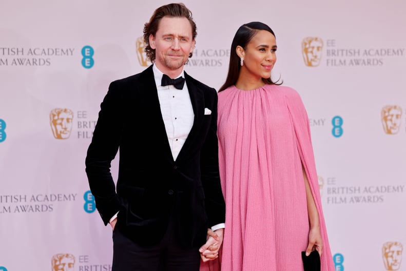 British actor Tom Hiddleston (L) and British actress Zawe Ashton pose on the red carpet upon arrival at the BAFTA British Academy Film Awards at the Royal Albert Hall, in London, on March 13, 2022. (Photo by Tolga Akmen / AFP) (Photo by TOLGA AKMEN/AFP vi