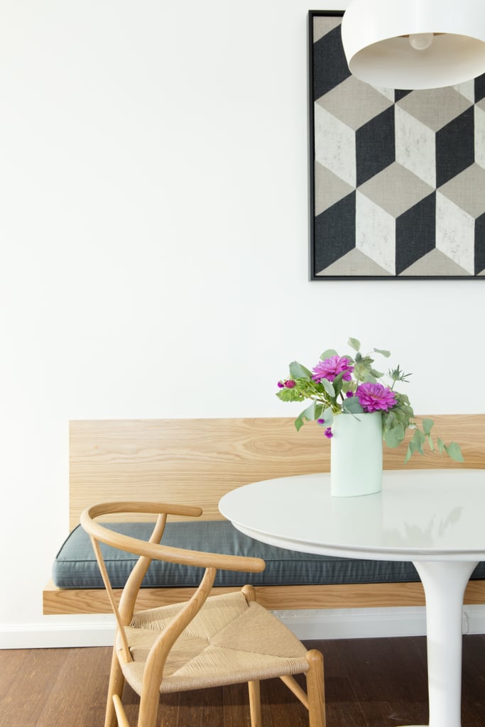 We love the combination of a modern lacquered tulip table and a Scandanavian-style wood chair.