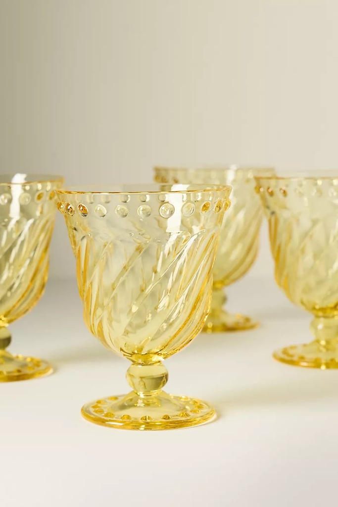 Anthropologie Esther Acrylic Goblets, Set of 4 ($34, originally $48)
Add a bit of personality to your glassware collection by opting for an accent color. From the spiral base to the beaded trim, the playful design makes even drinking water feel more fun. If you are searching for new hosting essentials, be sure to check out all the Anthropologie furniture and decor picks that are 30 percent off.