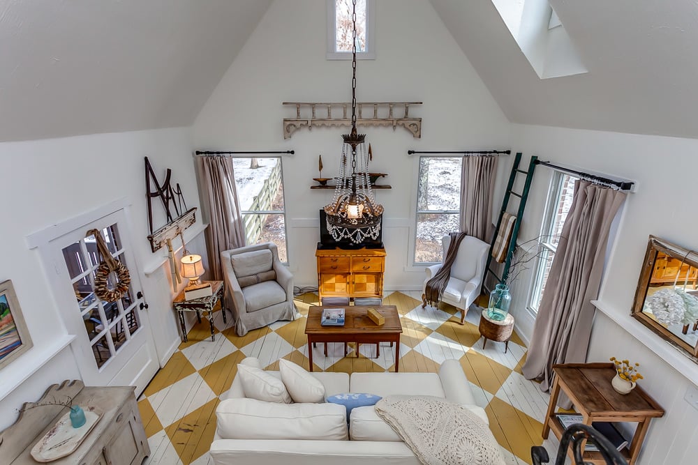 A look at the main living room from the loft. How cute is the yellow and white diamond-patterned floor?