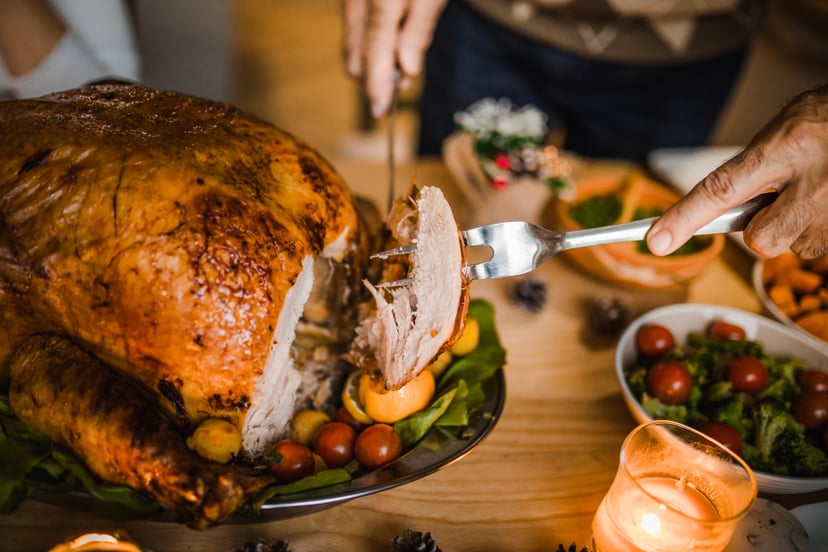 person carving thanksgiving turkey after defrosting turkey fast in cold water