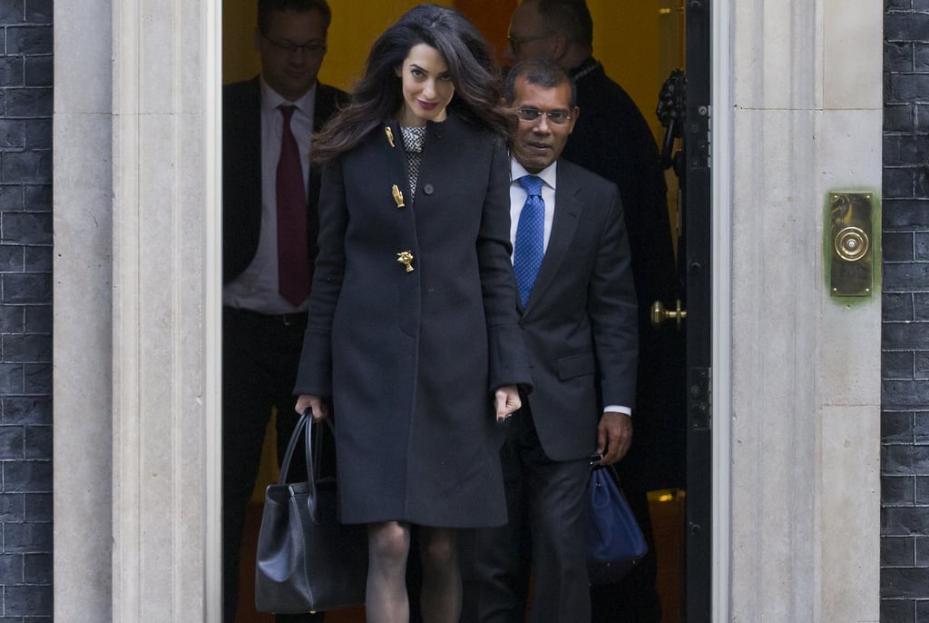 Amal Clooney Wearing a Black Coat With Gold Buttons
