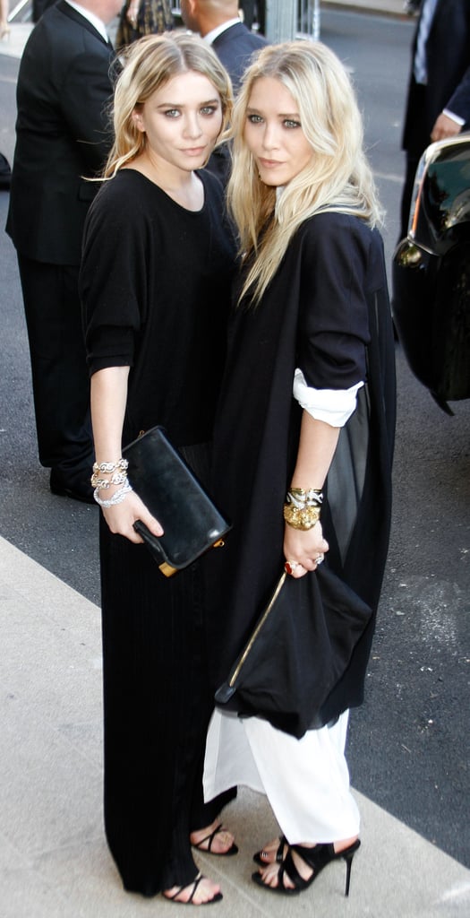 Twinning combo: Stacks of bracelets, slick black clutches, and strappy sandals? Check! The girls were ready to take on the big city in June 2007.

Ashley added a dash of dazzle to her black-on-black look with three diamond bracelets.
Mary-Kate layered an oversize black jacket over her white maxi, then slipped on a few animal bangles for the final touch.