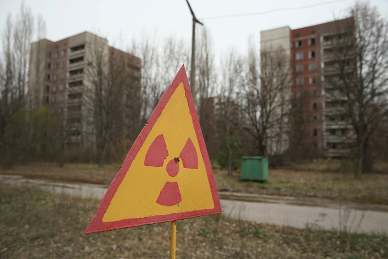 PRIPYAT, UKRAINE - APRIL 09:  A sign warns of radiation contamination near former apartment buildings on April 9, 2016 in Pripyat, Ukraine. Pripyat, built in the 1970s as a model Soviet city to house the workers and families of the Chernobyl nuclear power