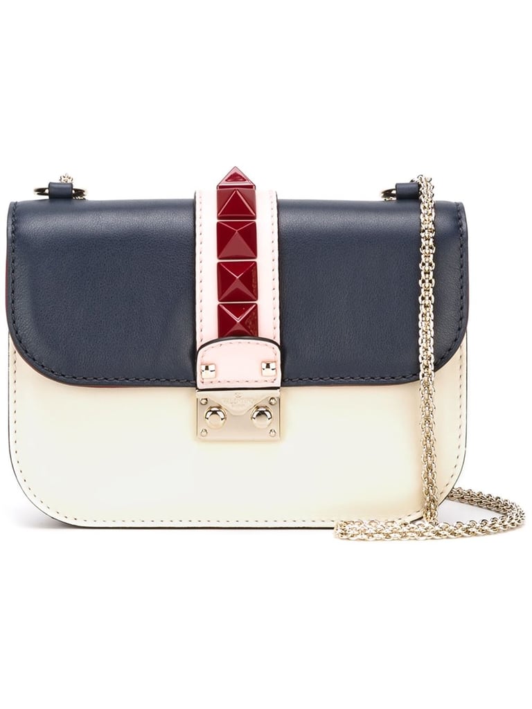 Don’t ask me why, but I was never crazy about the Valentino rockstuds — whether it be in shoe or bag form — until I saw this iteration. There’s something so luxe-looking about the Garavani Glam Lock satchel ($2,445), from its milky white leather detail to the subtle patriotic color scheme that’s dark enough to fit into my Fall wardrobe — and every other season, for that matter.
— SW