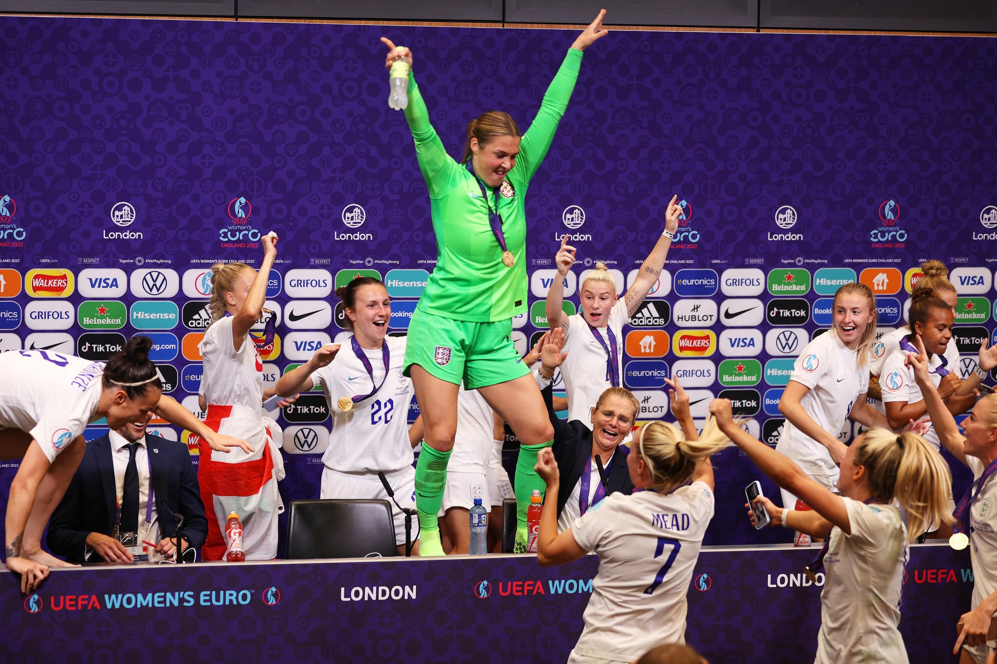 LONDON, ENGLAND - JULY 31: Mary Earps dance on the Press Conference table as players of England interrupt the Press Conference with Sarina Wiegman, Manager of England, after the UEFA Women's Euro 2022 final match between England and Germany at Wembley Stadium on July 31, 2022 in London, England. (Photo by Sarah Stier - UEFA/UEFA via Getty Images)