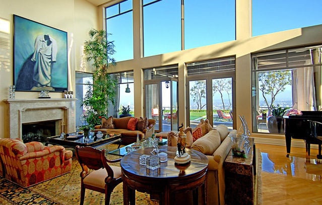 The indoor living space includes windows from floor to ceiling.