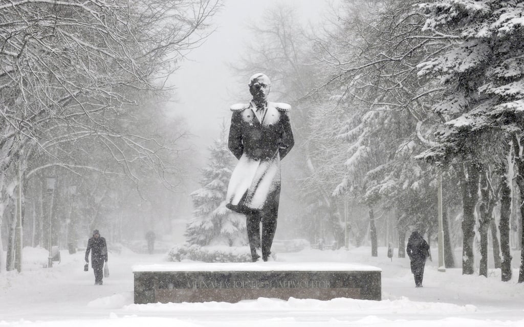 People in Stavropol, Russia, walked past a snow-covered monument to Russian poet Mikhail Lermontov.