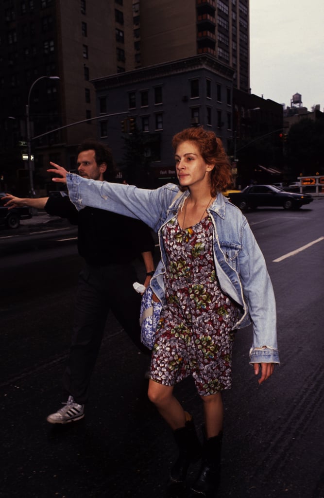 Looking like the quintessential '90s girl in a denim jacket layered over a floral dress while hailing a cab in NYC in 1991.