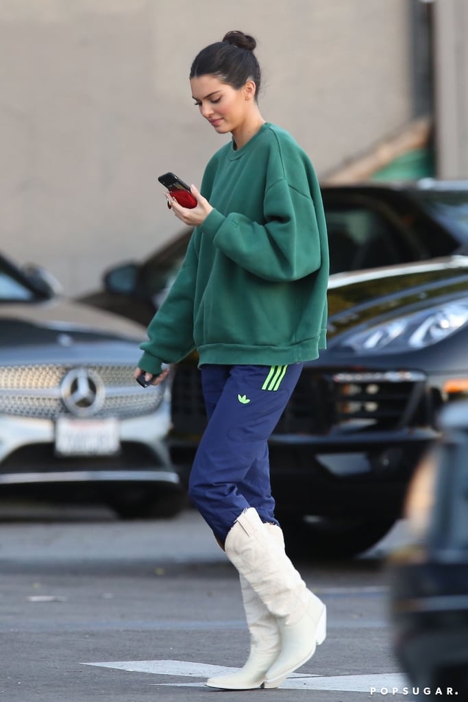 Kendall Jenner White Cowboy Boots and Adidas Track Pants