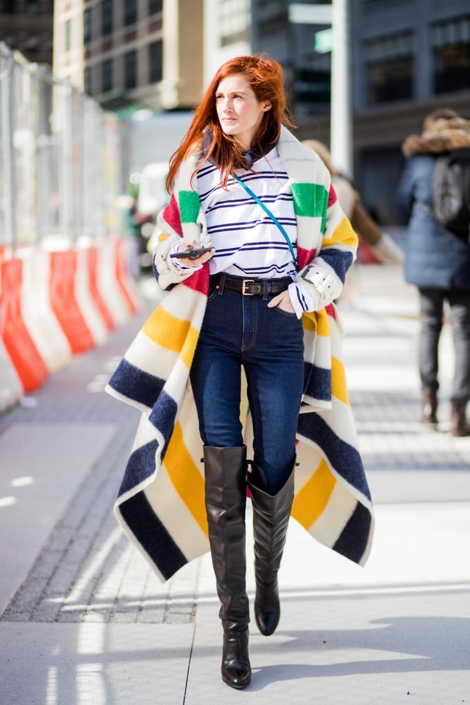 Taylor Tomasi Hill proves high-waisted, slim-fit denim is a perfect classic for anchoring bold stripes and statement boots.