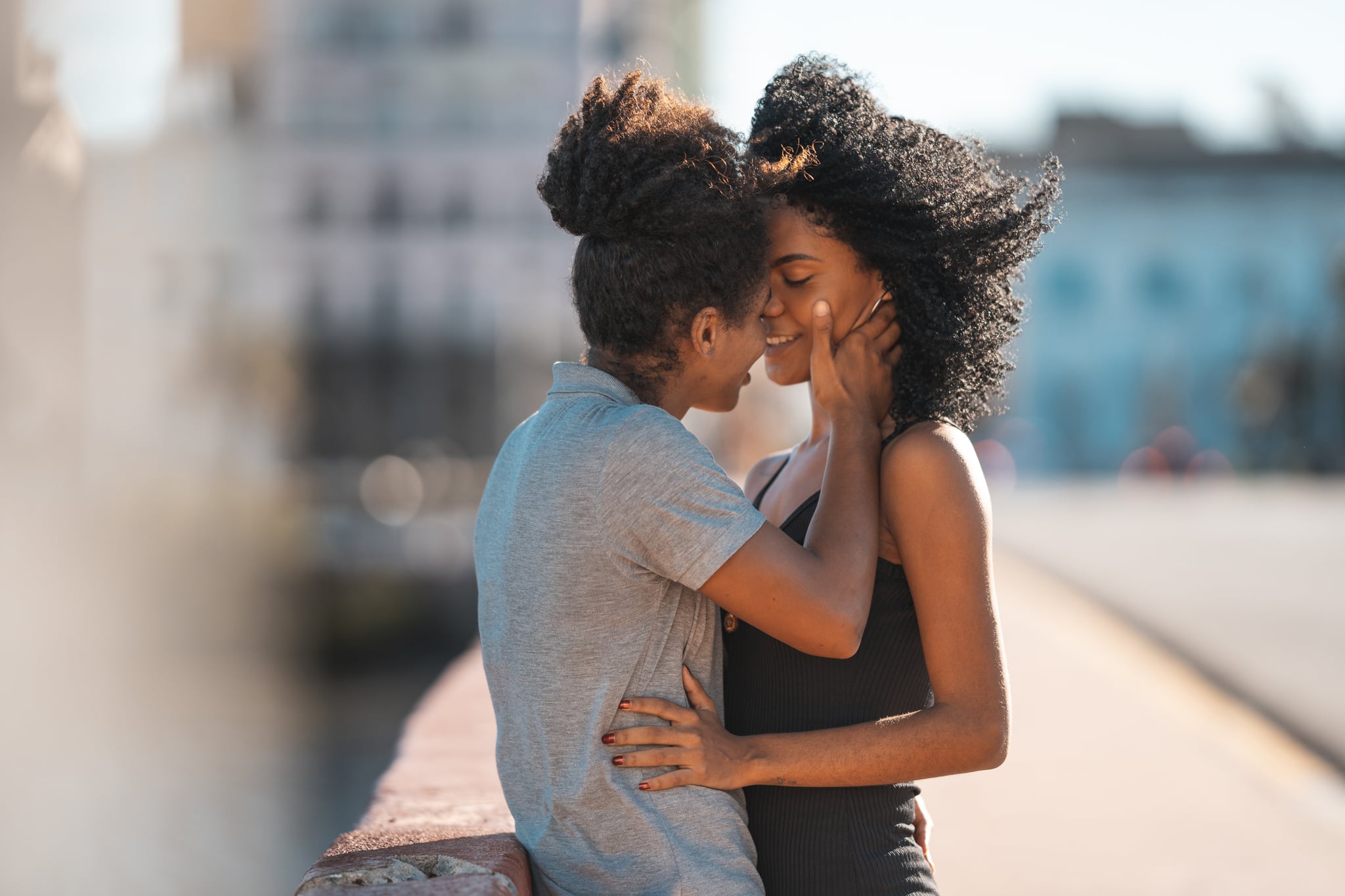 Woman on Top of Building Kissing in Wind