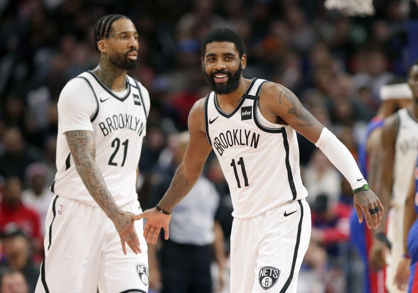 DETROIT, MI -  JANUARY 25:  Kyrie Irving #11 of the Brooklyn Nets celebrates with Wilson Chandler #21 of the Brooklyn Nets during the second half of a game against the Detroit Pistons at Little Caesars Arena on January 25, 2020, in Detroit, Michigan. The 