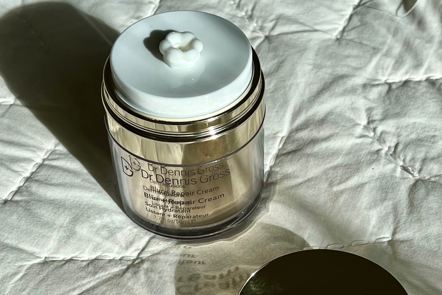 The Dr. Dennis Gross Skincare DermInfusions Blur + Repair Cream with product shown and lid off.<br />
