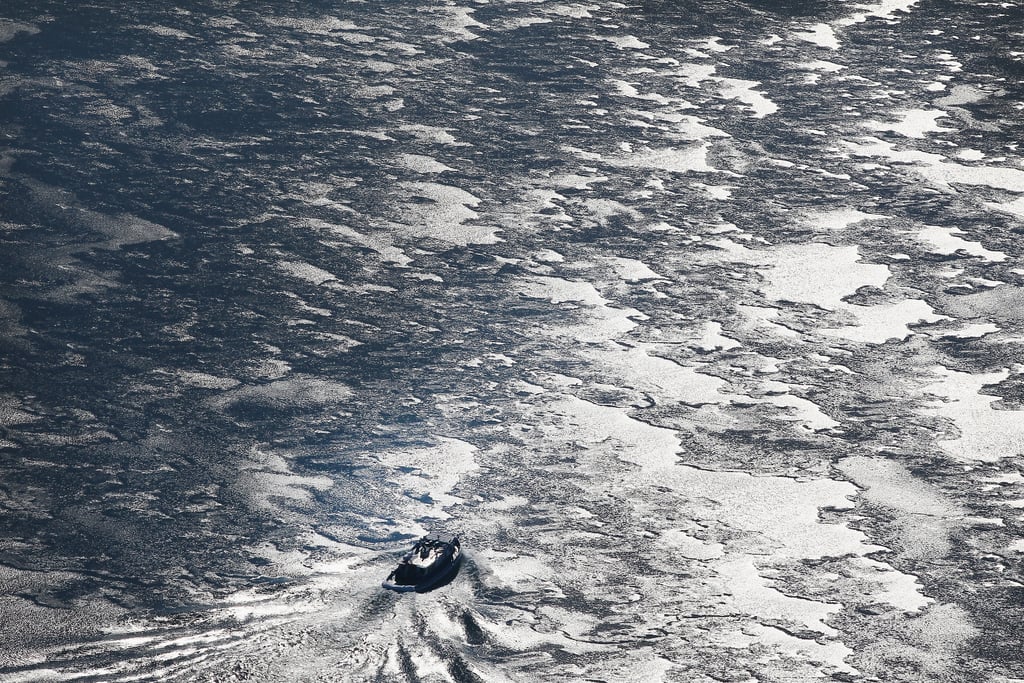 A boat broke through the ice to travel across Lake Michigan.