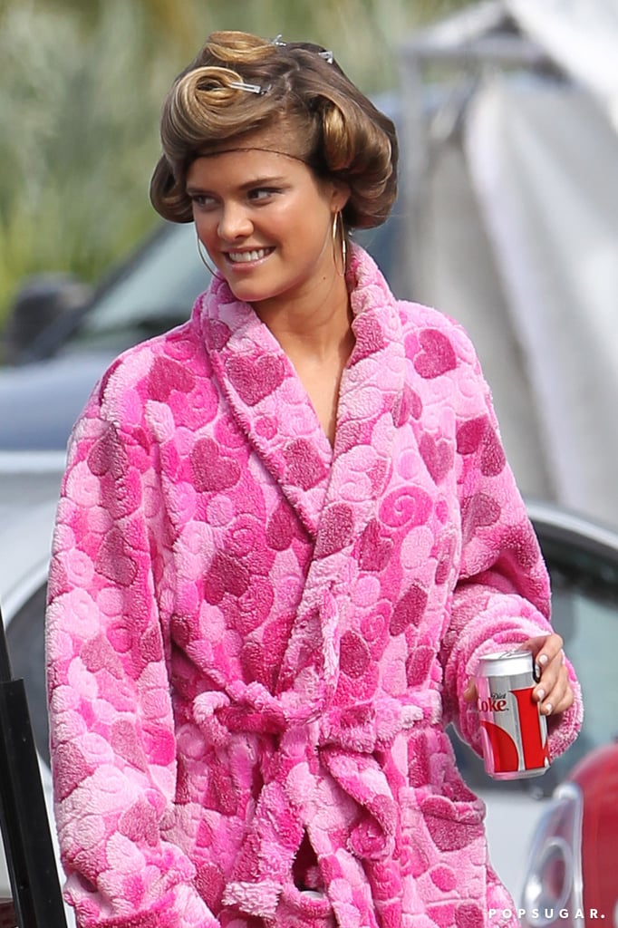 Nina Agdal showed up to set in a bright pink robe.