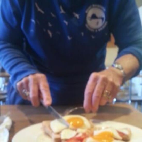 Woman Cuts Food For Breastfeeding Mom
