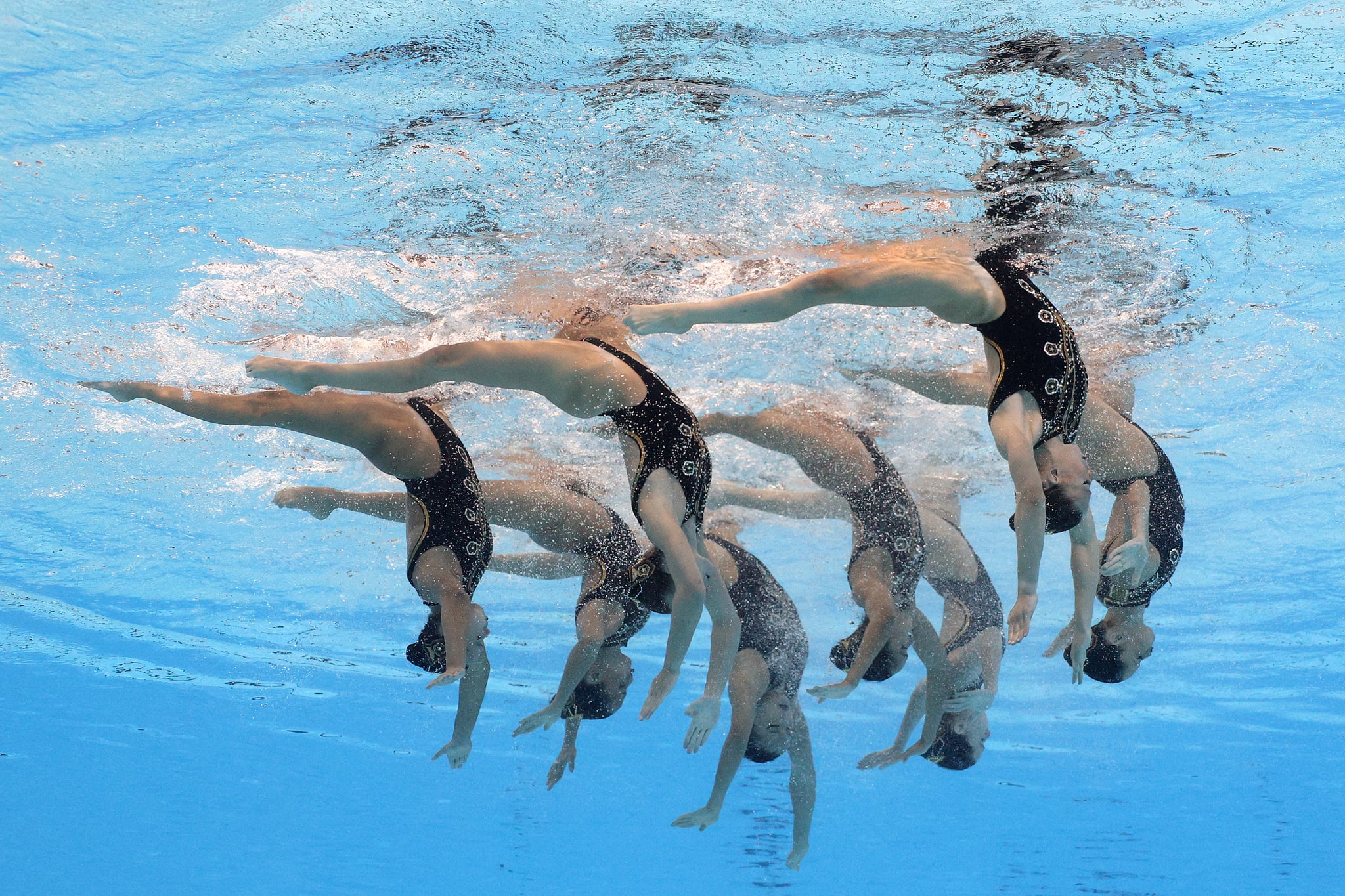 DOHA, QATAR - FEBRUARY 05: (EDITORS NOTE: Image taken using an underwater remote camera.) Anita Alvarez, Calista Liu, Jaime Czarkowski, Jacklyn Luu, Megumi Field, Daniella Ramirez, Keana Hunter and Ruby Remati of Team United States compete in the Mixed Team Technical Preliminaries on day four of the Doha 2024 World Aquatics Championships at Aspire Dome on February 05, 2024 in Doha, Qatar. (Photo by Quinn Rooney/Getty Images)