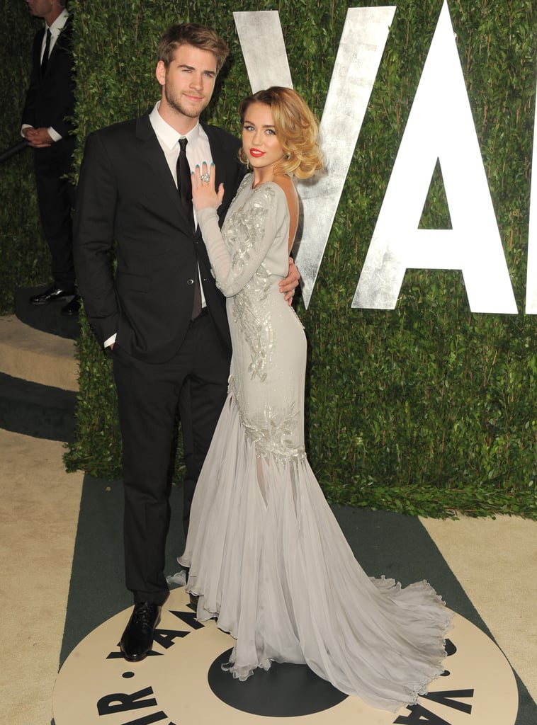 Miley holds on to her man Liam at the Vanity Fair party.
Miley holds on to her man Liam at the Vanity Fair party.