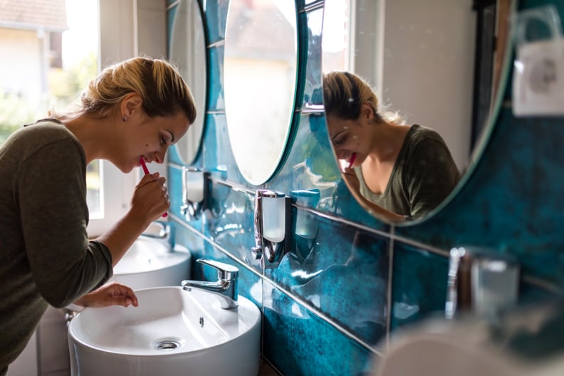 Young woman brushing teeth