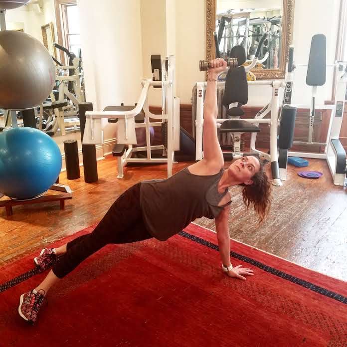 Why it’s effective: “Raise the level on your plank by rotating your torso and extending your arm overhead, firing up your triceps and obliques.”