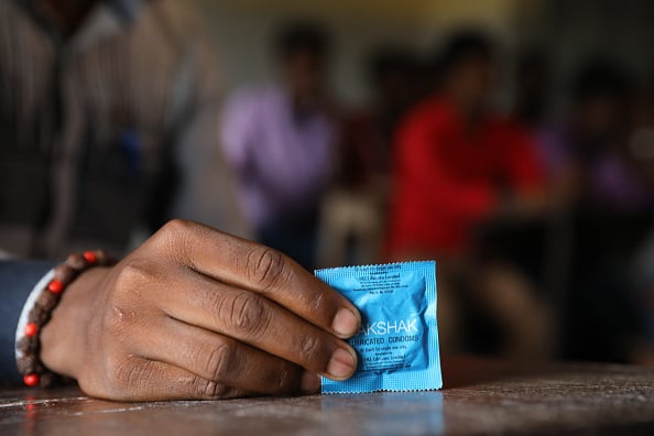 RANIGANJ,BIHAR, INDIA-NOVEMBER 15, 2017: A trainer from Pathfinder International demonstrates condom use for safe sex and pregnancy prevention to adolescent boys at the village school. These trainings are designed to engage youth ages 15 to 19 with intera
