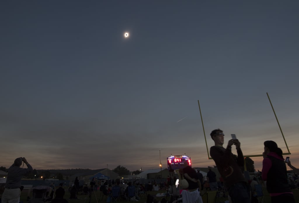 Over in Madras, OR, people watch the eclipse unfold at the Lowell Observatory Solar Eclipse Experience.