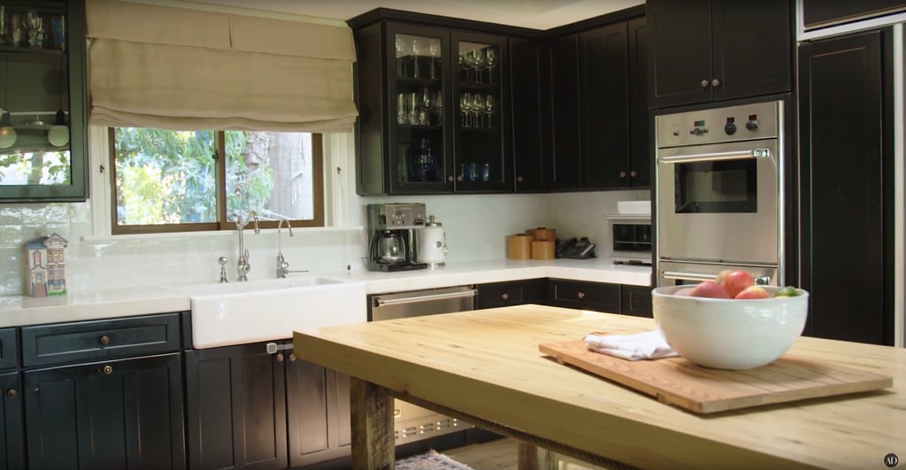 There's fresh fruit on the counter and wine glasses in the cabinets. There's fresh fruit on the counter and wine glasses in the cabinets.