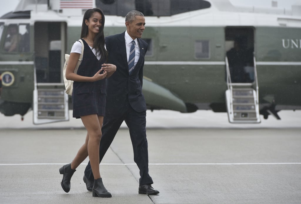 Wearing a black tank dress with pockets.