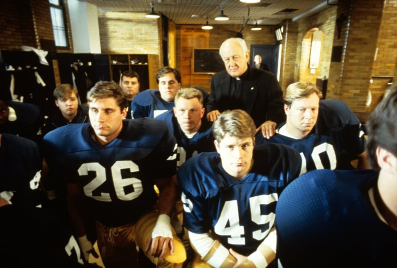 RUDY, Sean Astin (center right), Father James Riehle (back), 1993, TriStar Pictures/courtesy Everett Collection