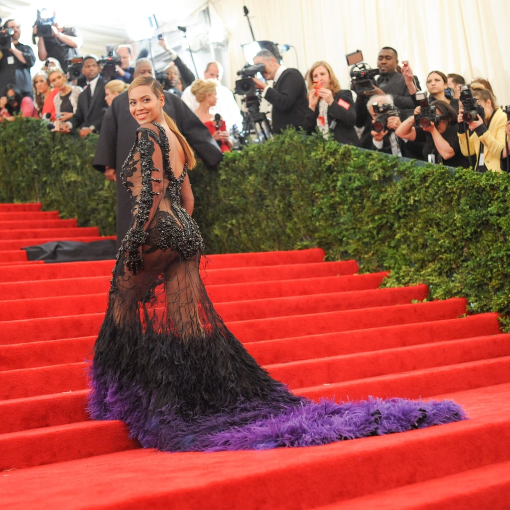 Wearing a black and purple feathered Givenchy gown to the Met Gala in 2012.
