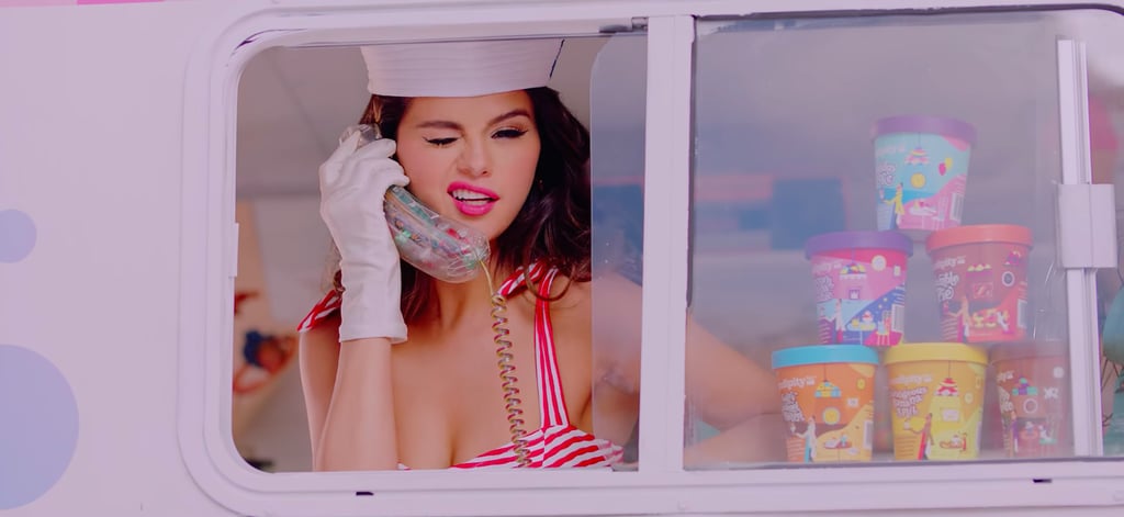 Selena Gomez is serving up frozen treats and hot retro looks. The singer recently released the over-the-top music video for her collaboration with Blackpink, "Ice Cream," in which she and the four-member girl group wear all sorts of flirty and ultrafeminine outfits. One of our favorite fashion moments, however, is when Selena pulls up in an old-school ice cream truck wearing a pin-up-style bikini, white gloves, and a sailor hat. (Cue hair flip.)  
Selena's striped bikini in the video is by Shoshanna and features tie straps, a high-waisted fit, and cute gold button accents. Selena completed the look with a pair of gold hoop earrings by Jennifer Fisher and, of course, makeup from her upcoming highly anticipated line, Rare Beauty, arriving Sept. 3. Shop Selena's bikini, and browse similar options ahead. 

    Related:

            
            
                                    
                            

            Selena Gomez Is Cooking Up a Feast on Her New Show and Served Up a Cute Blouse on the Side