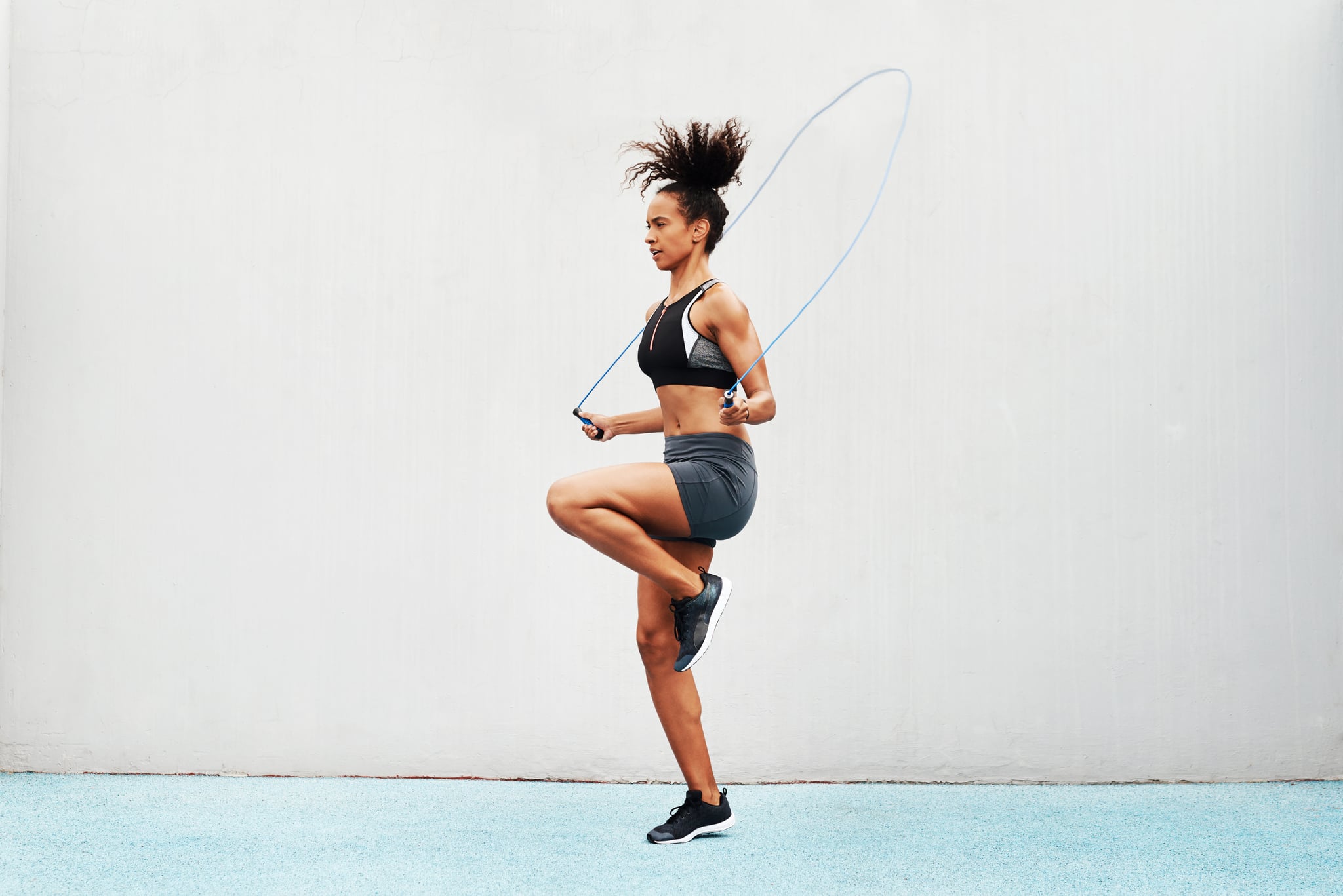 Full length shot of an attractive young athlete using a skipping rope during an outdoor training session