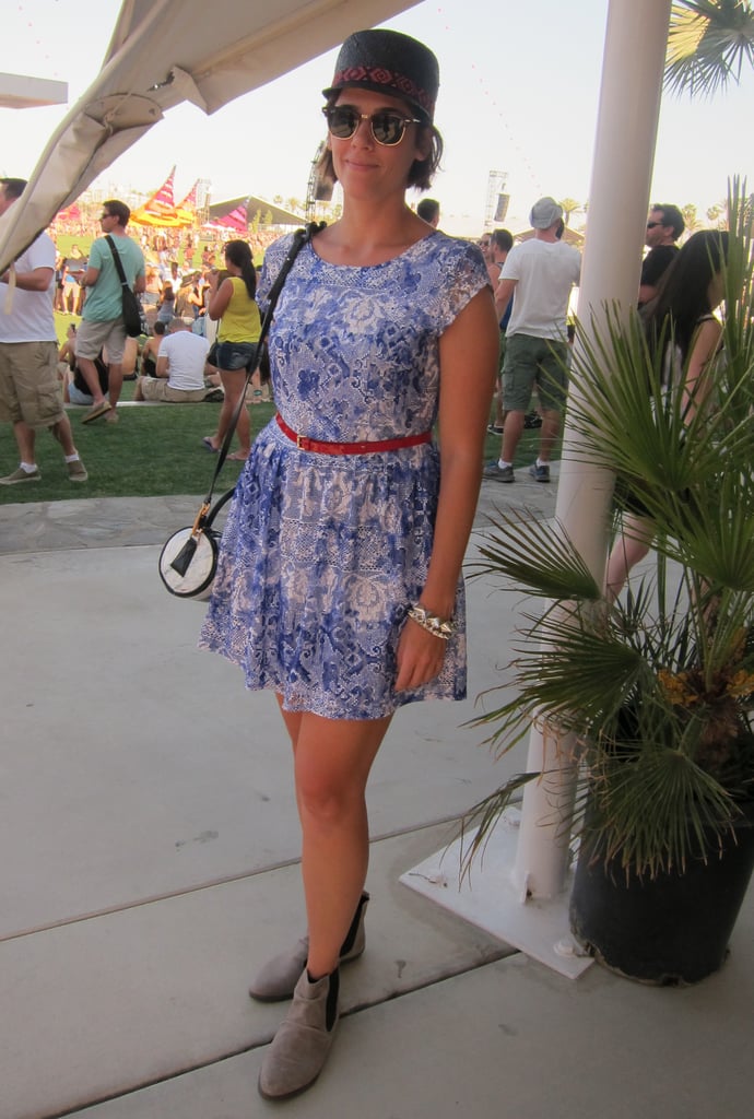 A sweet printed dress is accessorized with a bright red belt and feathered cap.
Source: Chi Diem Chau