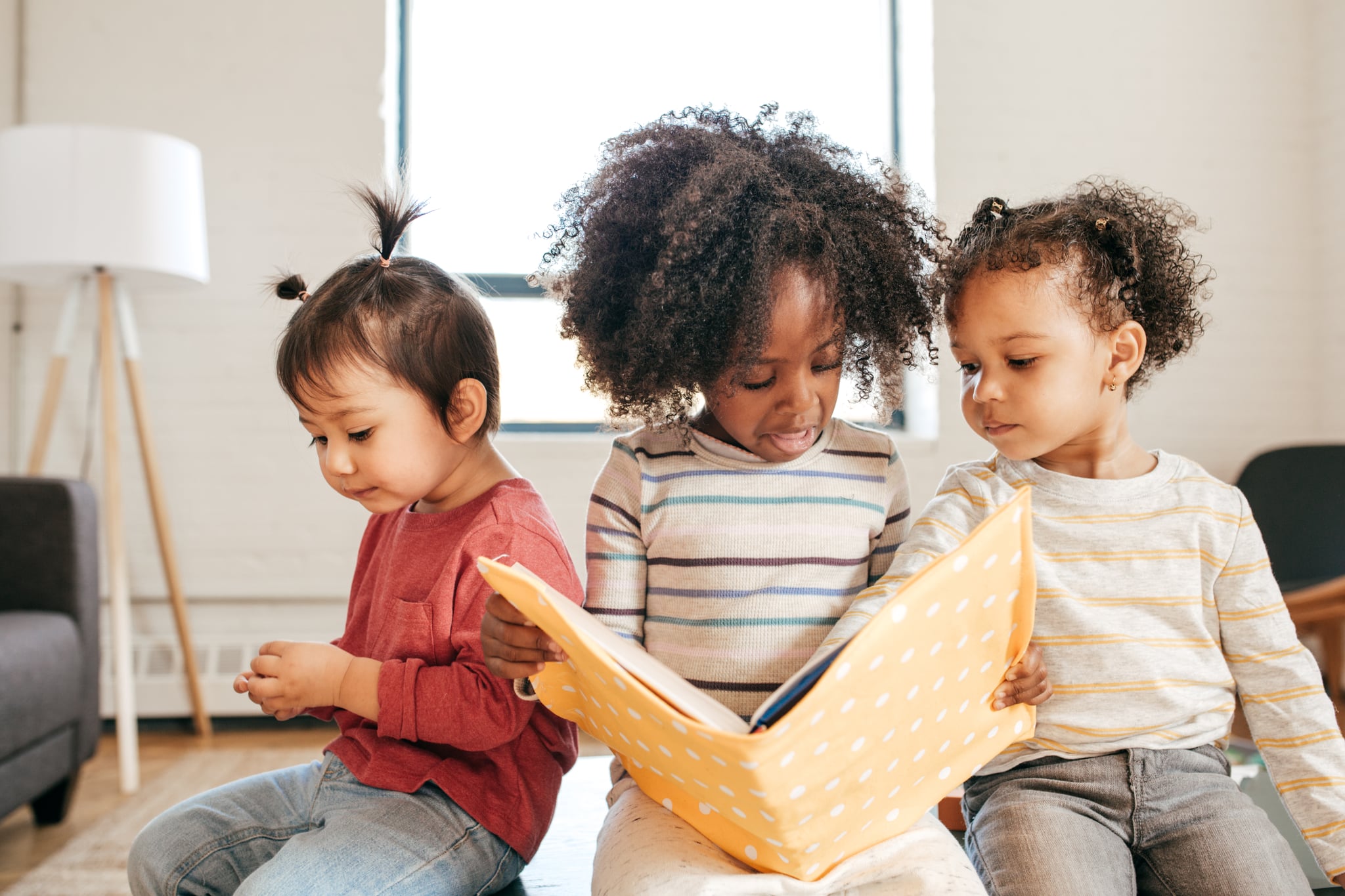 Toddlers busy with educational book