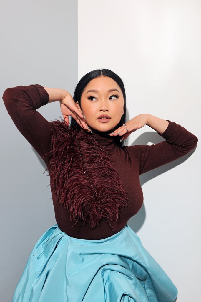 When you're hosting an event all about fashion, you dress accordingly. Lana Condor did not disappoint when she emceed the Costume Designers Guild Awards on Tuesday, wearing two very different yet equally daring looks. 
First up, Lana wore a colorful Prabal Gurung outfit consisting of black trousers, a turquoise bubble skirt, and a burgundy turtleneck with a large feather laid across one shoulder. Lana's stylist Tara Swennen said it was "important" that they supported the AAPI community with their choice of designer, and she went on to thank Prabal, who is Nepalese American, for the "amazing ensemble." The outfit was paired with platform heels by Stuart Weitzman, Vrai earrings, and a stunning aquamarine ring by Karma El Khalil. 
Whereas the Prabal look was more playful, Lana's second outfit of the evening was a sexy black lace dress by Christian Siriano, which revealed a strapless bra and high-waisted shorts underneath. The dress was accessorized with pointed-toe Jimmy Choo pumps and glitzy drop earrings and a statement ring by Raven Fine Jewelers. 
See photos of the contrasting outfits ahead.

    Related:

            
            
                                    
                            

            It&apos;s Time We Talked About Regina King&apos;s Epic Train at the Costume Designers Guild Awards