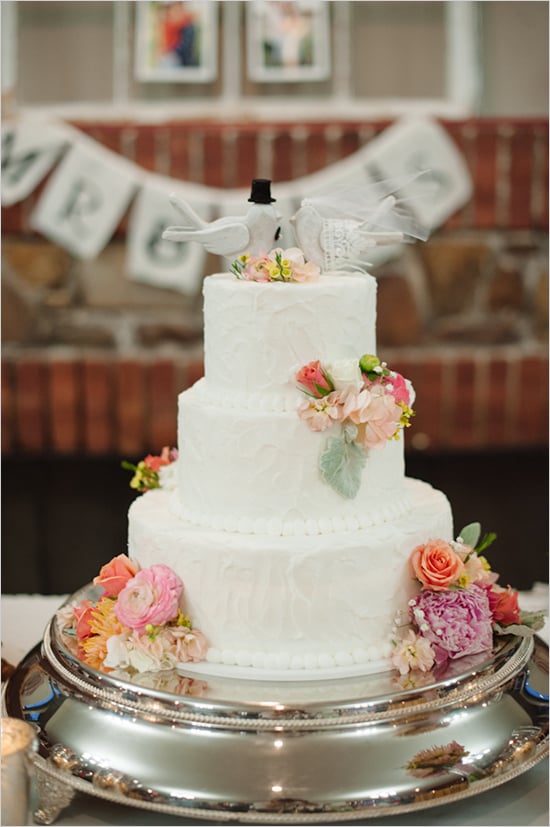From the doves to the florals to the white beads, everything about this cake says timeless. 
Photo by Brett Heidebrecht via Wedding Chicks