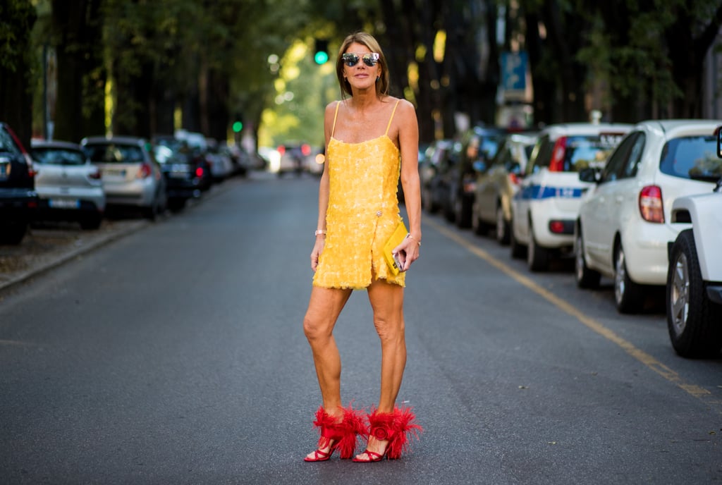 Anna Dello Russo didn't play it safe with her marigold dress. She wore a pair of fuzzy red heels with the mini for a pairing that beckons a perfect street style shot.