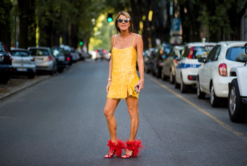 Anna Dello Russo didn't play it safe with her marigold dress. She wore a pair of fuzzy red heels with the mini for a pairing that beckons a perfect street style shot. Anna Dello Russo didn't play it safe with her marigold dress. She wore a pair of fuzzy red heels with the mini for a pairing that beckons a perfect street style shot.