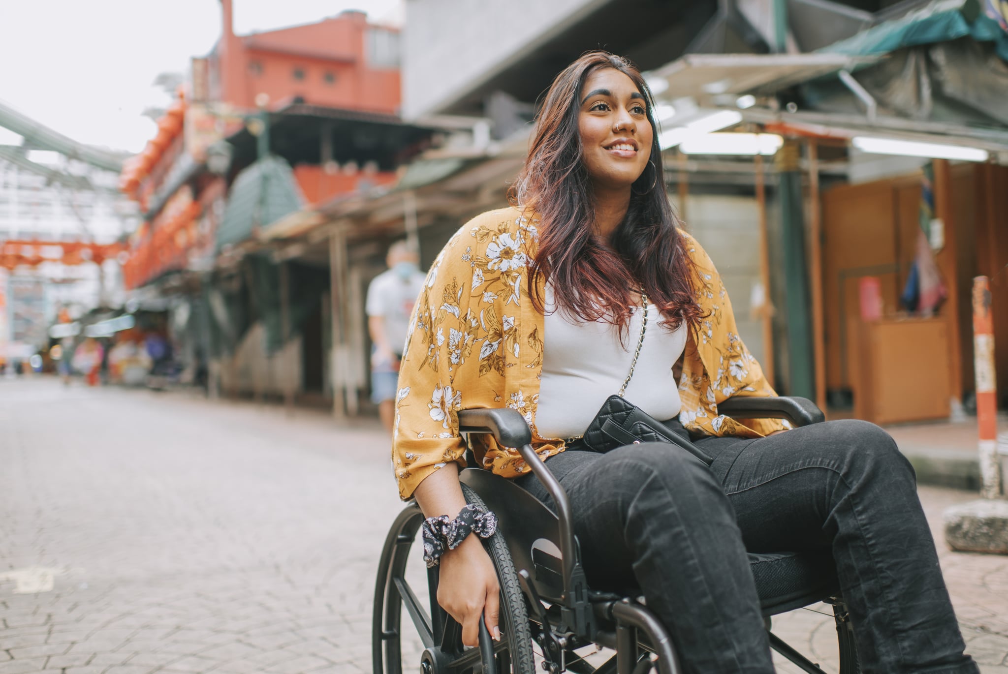 Woman In Wheelchair In Middle of City