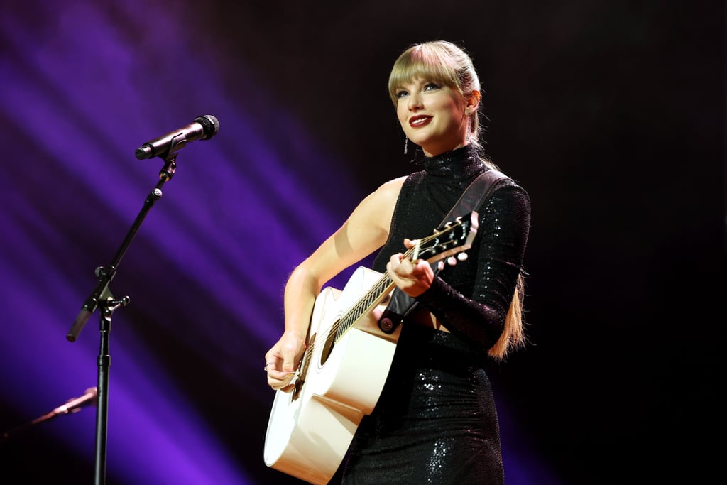 For Taylor Swift, a new album comes with a new era of style. The 11-time Grammy winner was honored with the songwriter-artist of the decade achievement at Wednesday evening's Nashville Songwriter Awards, where she dazzled in a black figure-hugging sequin gown. It was a sultrier choice for the singer, who started revealing her "Midnights" track list on TikTok just hours after the ceremony. The Michael Kors Collection design had all the elements of a sleek, striking dress: an asymmetrical hip cutout, one sleeve, and a high slit. 
With her signature blond hair styled into a long bubble ponytail, Swift teamed the mock-neck dress with sparkly Aquazzura sandals, drop earrings from Rahaminov Diamonds, and a ring by Anne Sisteron. As she performed the full 10-minute version of "All Too Well" and gave a speech about her approach to songwriting, her dress glistened at every turn. Swift has so far been leaning into lustrous embellishments and alluring silhouettes in her "Midnights" era, similar to her fashion during her "Reputation" period in 2017 and 2018. 
To tease her upcoming music during a surprise appearance at the MTV Video Music Awards in August, she wore an entirely sheer naked dress from Oscar de la Renta covered in draped crystals. For an afterparty later that night, she changed into a midnight-blue Moschino romper lined with crystals and adorned with sequin stars. More recently, on Sept. 11, Swift opted for another unexpected dress for the Toronto International Film Festival, a Louis Vuitton halter gown decorated with mirrored gold-coin details. 
See more photos of Swift's big moment ahead.