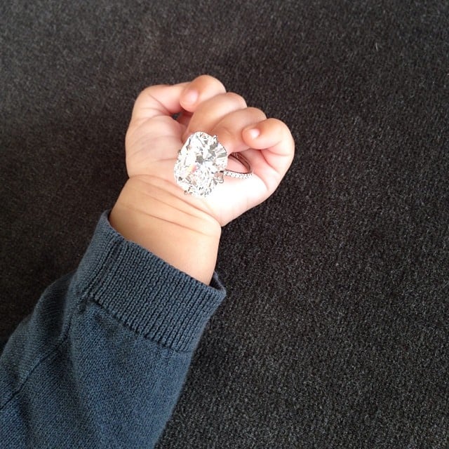 Kim Kardashian ended 2013 with a photo of her daughter, North West, holding the Lorraine Schwartz engagement ring fiancé Kanye West gave her. 
Source: Instagram user kimkardashian