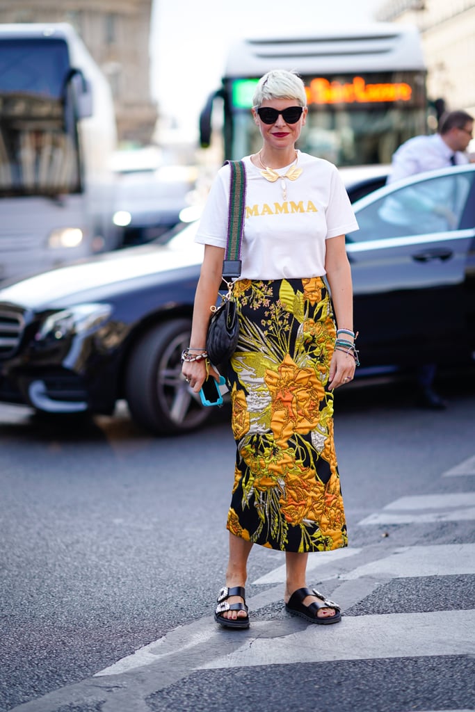 A graphic tee is fun with a printed midi skirt and embellished slides.