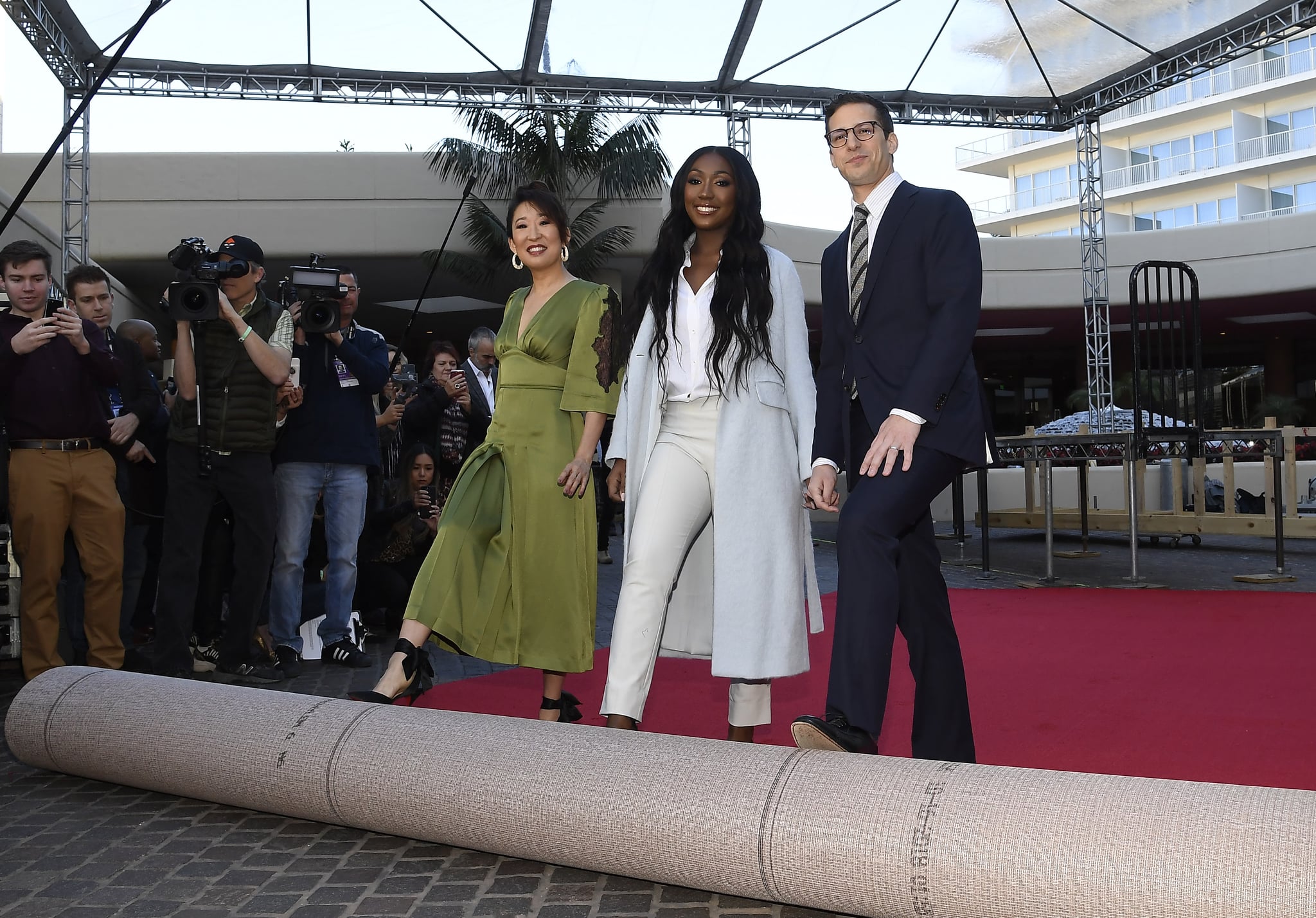 BEVERLY HILLS, CA - JANUARY 03: Sandra Oh (L) and Andy Samberg (R), hosts of the 76th Annual Golden Globe Awards, and Isan Elba (C), Golden Globe Ambassador, rollout the red carpet during a preview day at The Beverly Hilton Hotel on January 3, 2019 in Beverly Hills, California. (Photo by Kevork Djansezian/Getty Images)