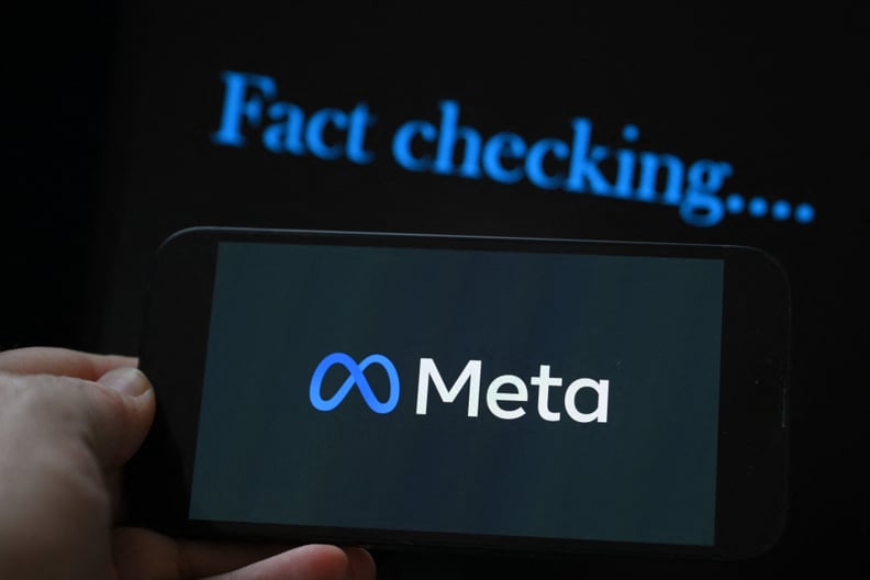 This photo illustration created on January 8, 2025, in Brussels, shows the media giant Meta's logo displayed on a smartphone and screen displaying the words fact checking.