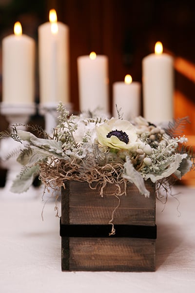 For a homespun look, fill wooden boxes with monochromatic blooms. Cotton balls and anemones add a unique touch!