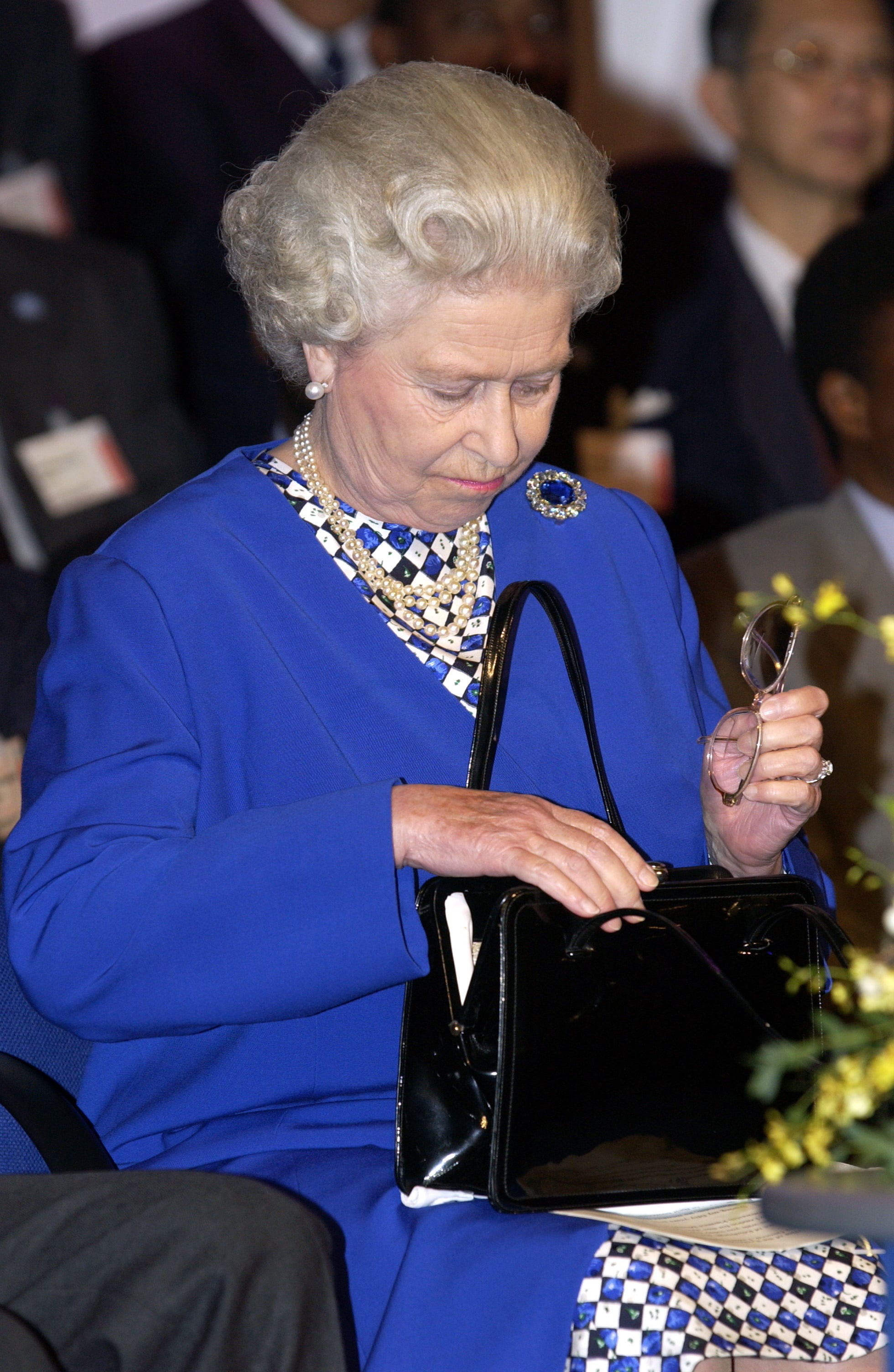 Why Does the Queen Always Carry a Purse?